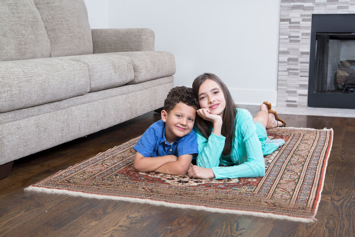 children laying on area rug