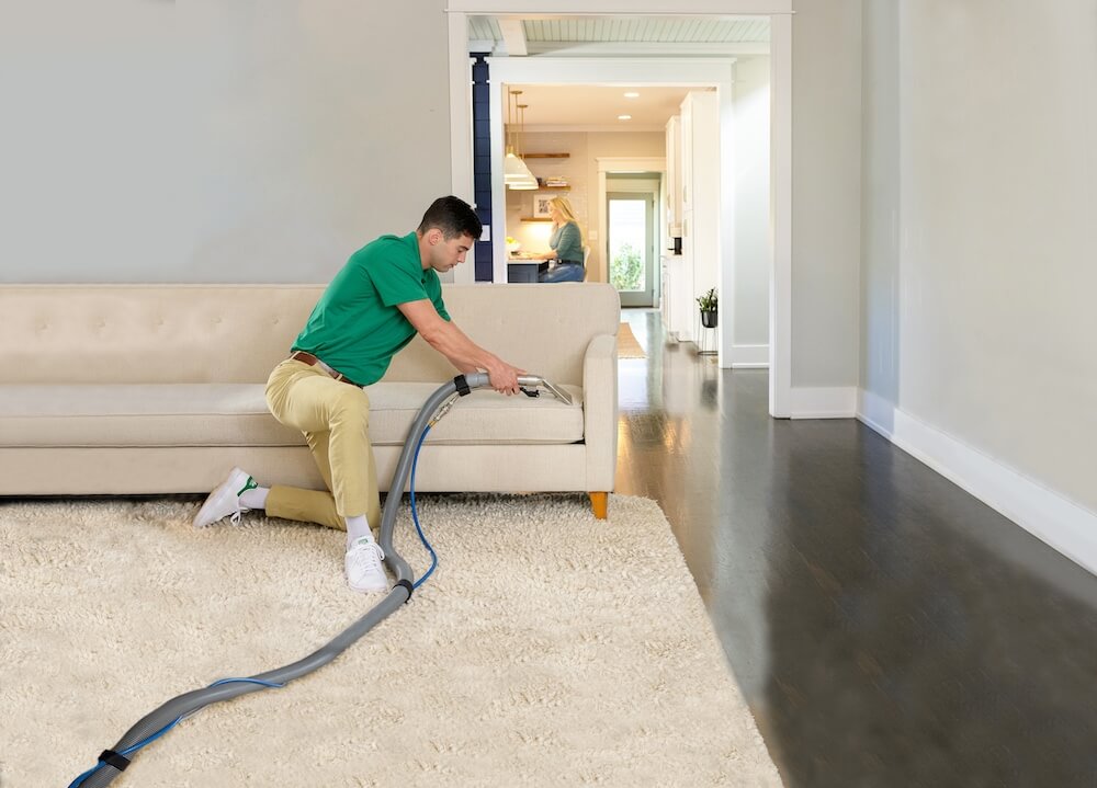 new-upholstery-cleaning a man working hard to clean some upholstery